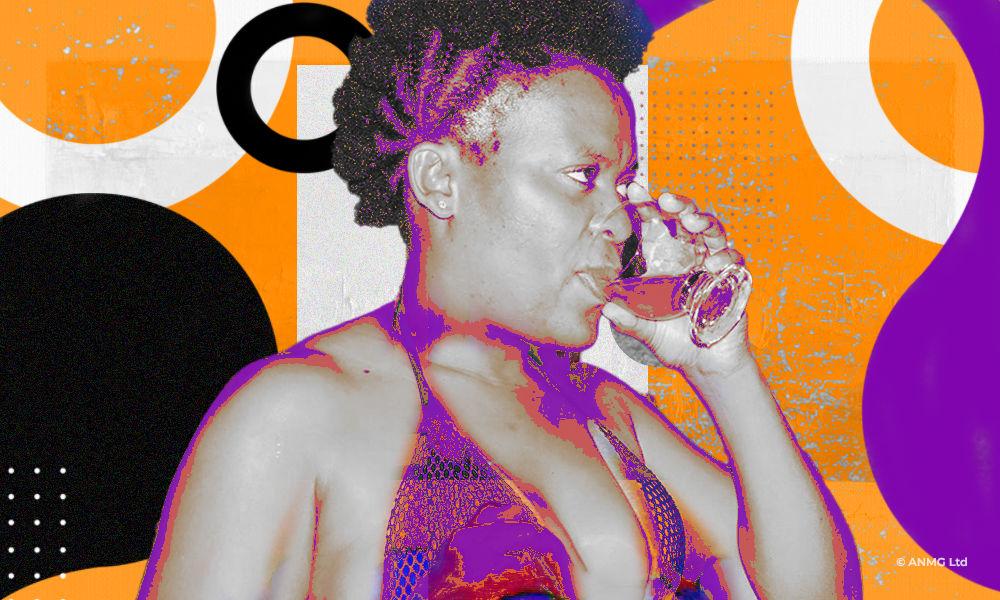 Zodwa Wabantu taking a drink from a small glass - in a bra